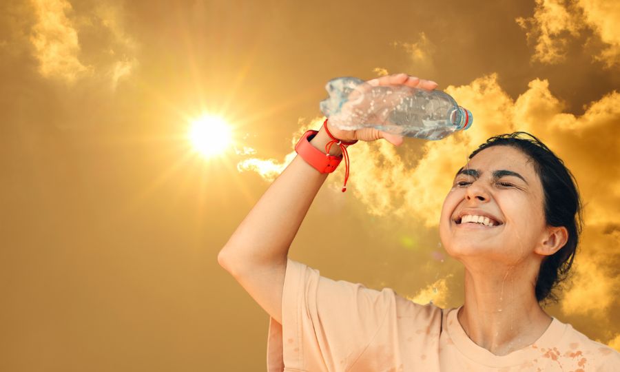Woman drinking water during Indian summer